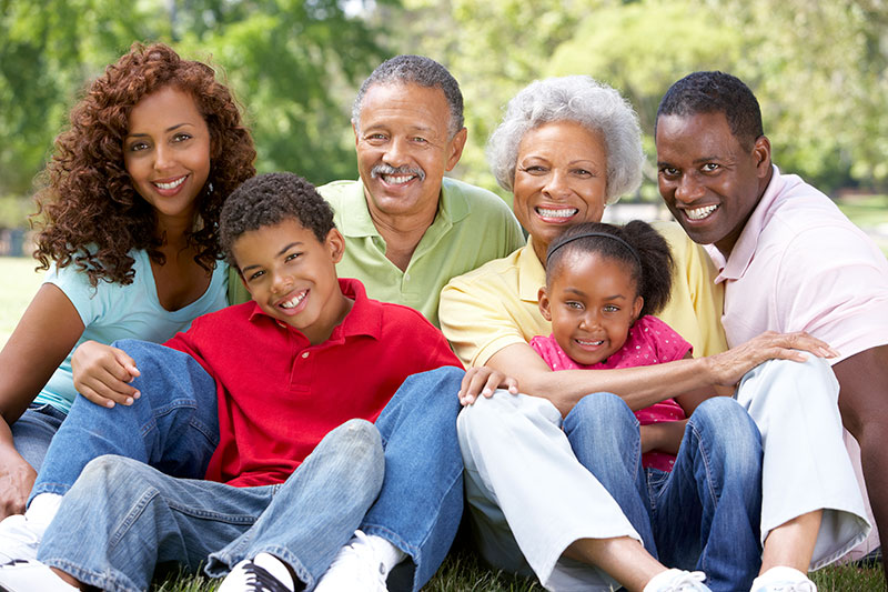 Family smiling with children, parents, and grandparents
