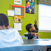 A boy raising his hand in class