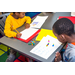 A boy practicing his math skills with blocks