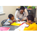 A teacher writing with a marker helping a child