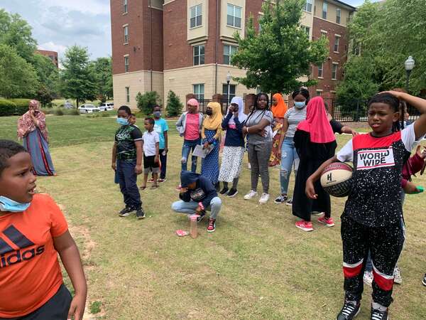 people standing together in the grass