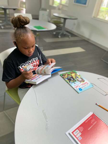 girl sitting down reading a book