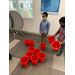 two boys standing by buckets on the floor