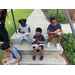 children reading books by staircase