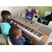 two boys playing the piano
