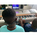 boys hitting keys on the piano