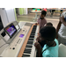 group of children playing the piano