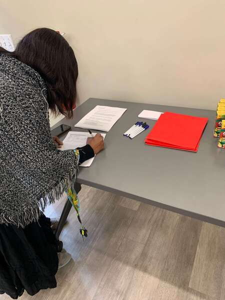 woman writing on a piece of paper