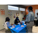 woman talking to another woman by a table