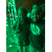 two children standing next to green lights