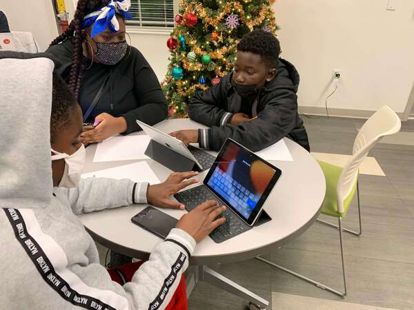 two boys using laptops