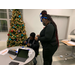 woman and young boy sitting next to christmas tree