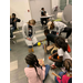 children sitting on the floor with their crafts