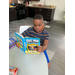 boy reading book by himself