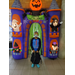 boy standing in front of halloween decorations