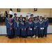 group of people standing together with caps and gowns on