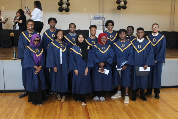 group of people standing together with caps and gowns on