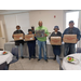 group of people holding boxes of ham