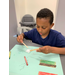 boy making crafts with popsicle sticks
