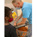 man showing children how to make crafts