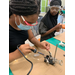 girl using a tool to make crafts