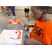 a boy using a glue stick