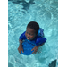 a boy floating in a pool