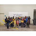 group of children standing in front of a classroom