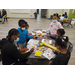 group of children coloring on pieces of paper