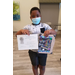 boy holding an award and an art set