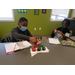 two boys playing at a table