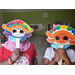 children holding masks up to their faces