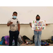 two children standing in the front of the room