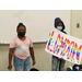 two children holding a sign standing up