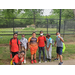 group of boys standing in front of a fence