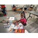 a girl cutting up magazines with scissors