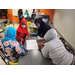 four kids looking at a piece of paper