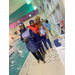 three girls standing next to a pool