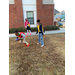 Two boys playing football and a girl watching them