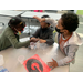 a girl and two boys working on a science experiment