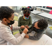 Two boys and a girl working together to complete a science experiment